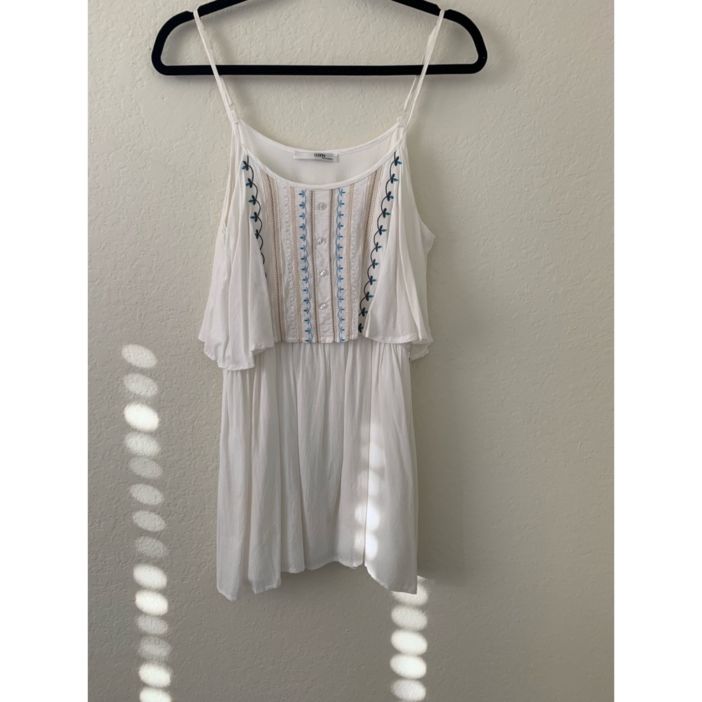 Woman’s white short dress with embroidered front.